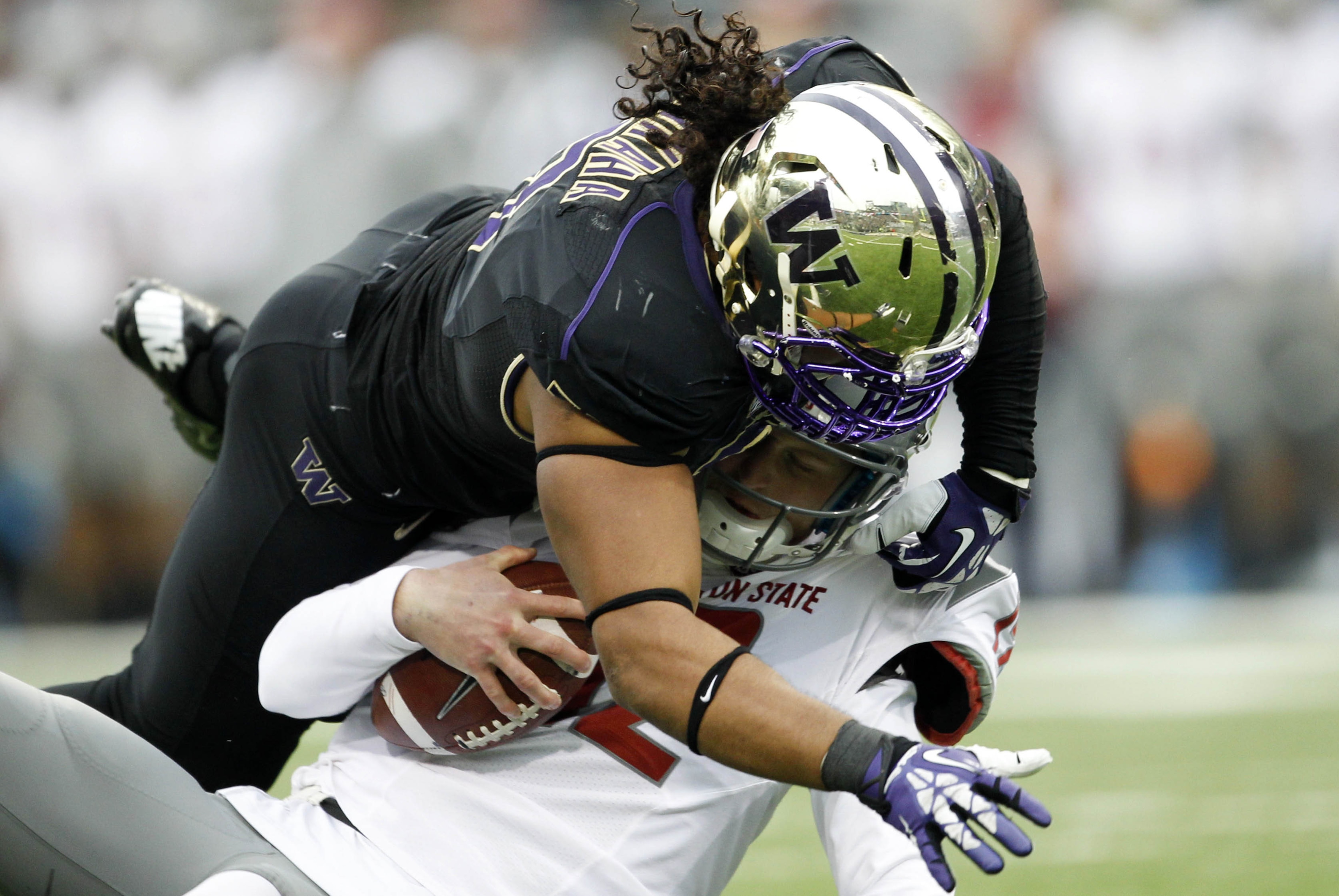 Nov 29, 2013; Seattle, WA, USA; Washington Huskies defensive end Hau'oli Kikaha (8) sacks Washington State Cougars quarterback Connor Hlliday (12) during the second quarter at Husky Stadium. Mandatory Credit: Joe Nicholson-USA TODAY Sports