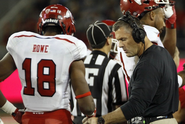 Utah's head coach Kyle Whittingham, right, congratulates Eric Rowe (18) on a defensive play against Arizona in the second half of an NCAA college football game, Saturday, Oct. 19, 2013 in Tucson, Ariz. Arizona won 35 - 24. (AP Photo/Wily Low)