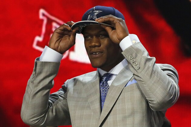 Nebraska defensive lineman Randy Gregory celebrates after being selected by the Dallas Cowboys as the 60th pick in the second round of the 2015 NFL Football Draft,  Friday, May 1, 2015, in Chicago. (AP Photo/Charles Rex Arbogast)