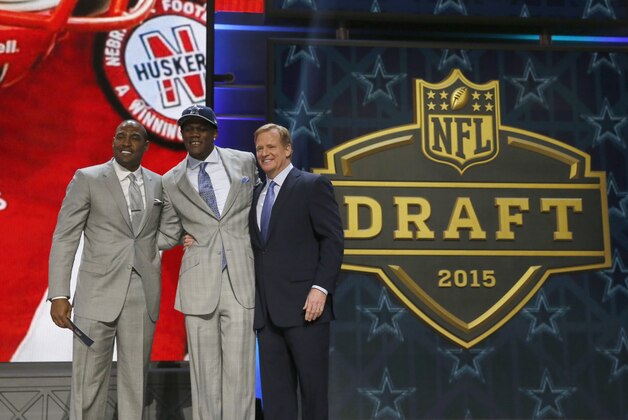 Nebraska defensive lineman Randy Gregory poses for photos with former the Dallas Cowboys player Darren Woodson, left, and NFL commissioner Roger Goodell after being selected by the Cowboys as the 60th pick in the second round of the 2015 NFL Football Draft,  Friday, May 1, 2015, in Chicago. (AP Photo/Charles Rex Arbogast)