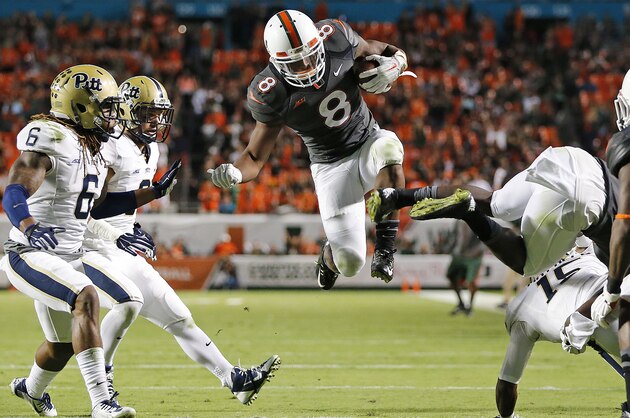 MIAMI GARDENS, FL - NOVEMBER 29: Duke Johnson #8 of the Miami Hurricanes dives towards the end zone to score a third period touchdown against the Pittsburgh Panthers on November 29, 2014 at Sun Life Stadium in Miami Gardens, Florida. (Photo by Joel Auerbach/Getty Images)