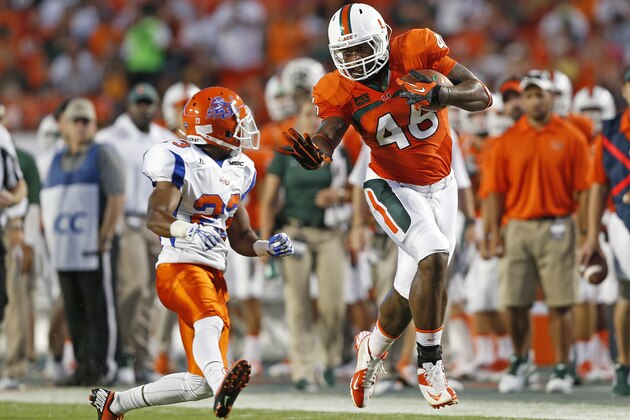 MIAMI GARDENS, FL - SEPTEMBER 21: Clive Walford #46 of the Miami Hurricanes runs with the ball while being defended by Romahn Hemingway #23 of the Savannah State Tigers on September 21, 2013 at Sun Life Stadium in Miami Gardens, Florida. Miami defeated Savannah State 77-7. (Photo by Joel Auerbach/Getty Images)