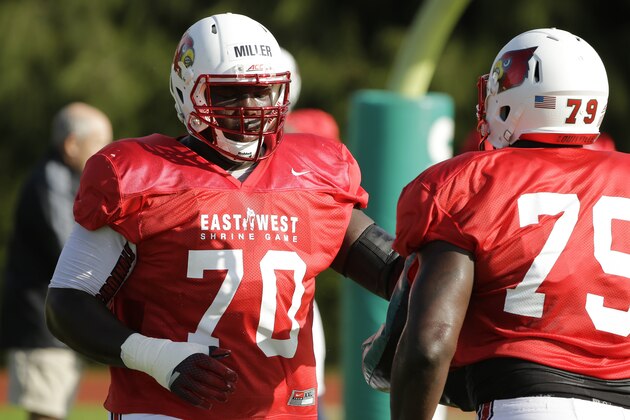 East lineman John Miller, of Louisville, left, blocks Jamon Brown, of Louisville,  during practice for the East-West Shrine college football game Tuesday, Jan. 13, 2015, in St. Petersburg, Fla. (AP Photo/Chris O'Meara)