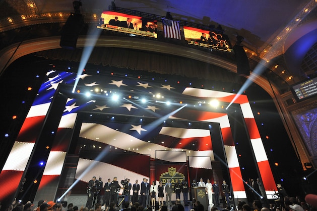 Members of the United States military line the stage during the third round of the 2015 NFL Football Draft,  Friday, May 1, 2015, in Chicago. (AP Photo/Paul Beaty)