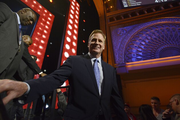 NFL commissioner Roger Goodell walks around the Auditorium Theater to meet fans during in the third round of the 2015 NFL Football Draft,  Friday, May 1, 2015, in Chicago. (AP Photo/Paul Beaty)