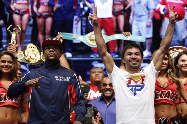 Floyd Mayweather Jr., left, and Manny Pacquiao pose during their weigh-in on Friday, May 1, 2015 in Las Vegas. The world weltherweight title fight between Mayweather Jr. and Pacquiao is scheduled for May 2. (AP Photo/John Locher)