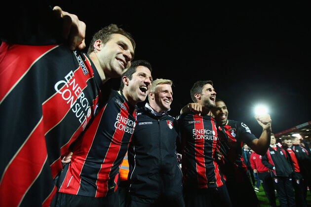 BOURNEMOUTH, ENGLAND - APRIL 27:  (L-R) Brett Pitman, Yann Kermorgant, Eddie Howe manager of Bournemouth, Andrew Surman and Callum Wilson of Bournemouth celebrate victory on the pitch after the Sky Bet Championship match between AFC Bournemouth and Bolton Wanderers at Goldsands Stadium on April 27, 2015 in Bournemouth, England. Bournemouth's 3-0 victory puts them on the brink of promotion to the Barclays Premier League.  (Photo by Clive Rose/Getty Images)