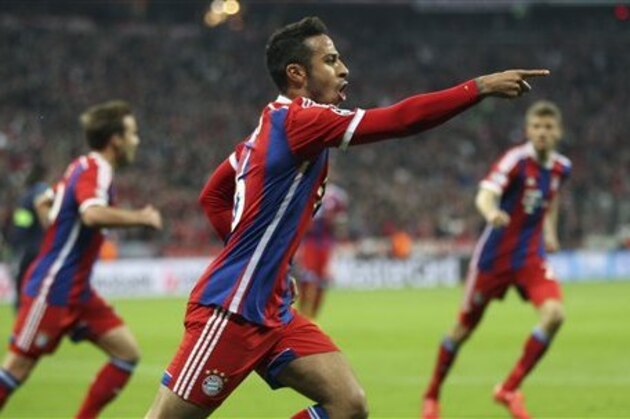 Bayern's Thiago celebrates after scoring the opening goal during the soccer Champions League quarterfinal second leg match between Bayern Munich and FC Porto at the Allianz Arena in Munich, southern Germany, Tuesday, April 21, 2015. (AP Photo/Michael Probst)