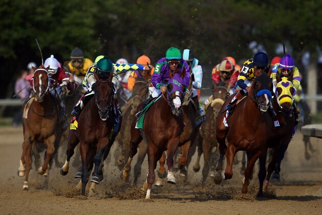 LOUISVILLE, KY - MAY 03:  Jockey Victor Espinoza guides California Chrome #5 to the finish line to win the 140th running of the Kentucky Derby at Churchill Downs on May 3, 2014 in Louisville, Kentucky.  (Photo by Andy Lyons/Getty Images)