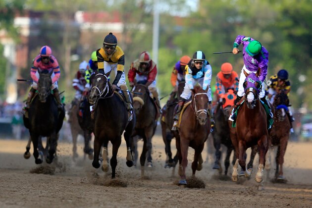 LOUISVILLE, KY - MAY 03:  Jockey Victor Espinoza celebrates atop of California Chrome #5 after crossing the finish line to win the 140th running of the Kentucky Derby at Churchill Downs on May 3, 2014 in Louisville, Kentucky.  (Photo by Rob Carr/Getty Images)