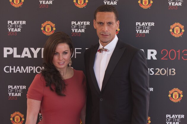 Manchester United's Rio Ferdinand arrives with his wife Rebecca Ellison at the team's Player of the Year Awards dinner at Old Trafford Stadium, Manchester, England, Wednesday May 15, 2013. (AP Photo/Jon Super)