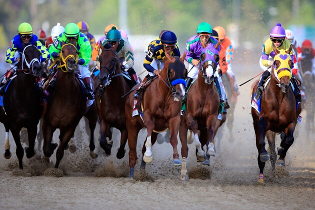 LOUISVILLE, KY - MAY 03:  Jockey Victor Espinoza guides California Chrome #5 to the finish line to win the 140th running of the Kentucky Derby at Churchill Downs on May 3, 2014 in Louisville, Kentucky.  (Photo by Rob Carr/Getty Images)