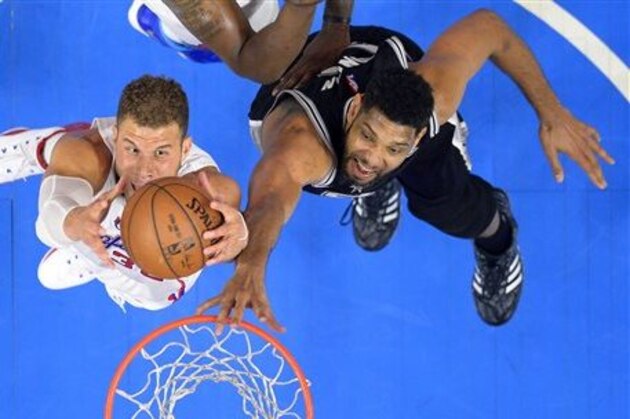 Los Angeles Clippers forward Blake Griffin, left, grabs a rebound away from San Antonio Spurs forward Tim Duncan during the first half of Game 5 of a first-round NBA basketball playoff series, Tuesday, April 28, 2015, in Los Angeles. (AP Photo/Mark J. Terrill)