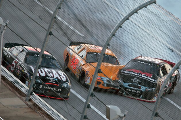 Austin Wayne Self, right, spins into Brad Smith (48) as Bobby Gerhart (5) passes them in the tri-oval during the ARCA Series auto race at Talladega Superspeedway, Friday, May 1, 2015, in Talladega, Ala. (AP Photo/Butch Dill)