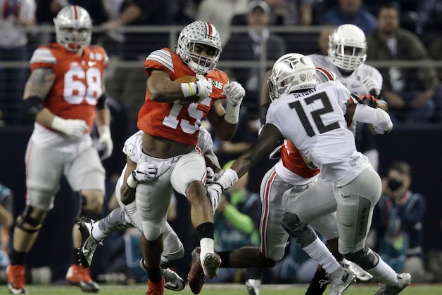 Ohio State running back Ezekiel Elliott (15) runs during the first half of the NCAA college football playoff championship game against Oregon Monday, Jan. 12, 2015, in Arlington, Texas. (AP Photo/LM Otero)