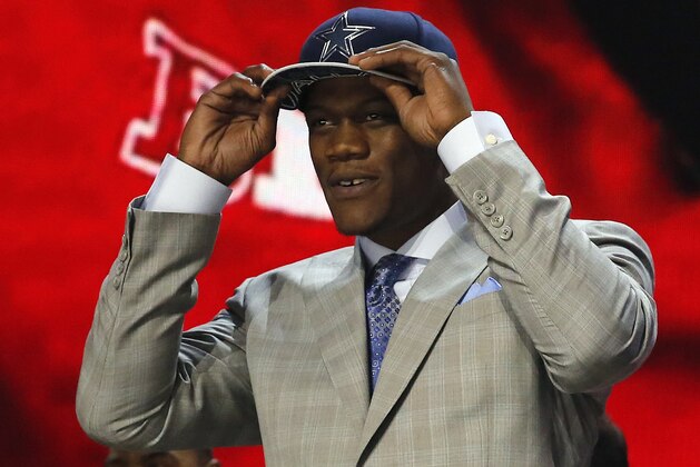 Nebraska defensive lineman Randy Gregory celebrates after being selected by the Dallas Cowboys as the 60th pick in the second round of the 2015 NFL Football Draft,  Friday, May 1, 2015, in Chicago. (AP Photo/Charles Rex Arbogast)