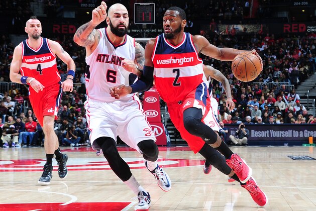 ATLANTA, GA - JANUARY 11: John Wall #2 of the Washington Wizards drives against Pero Antic #6 of the Atlanta Hawks on January 11, 2015 at Philips Arena in Atlanta, Georgia.  NOTE TO USER: User expressly acknowledges and agrees that, by downloading and/or using this Photograph, user is consenting to the terms and conditions of the Getty Images License Agreement. Mandatory Copyright Notice: Copyright 2015 NBAE (Photo by Scott Cunningham/NBAE via Getty Images)
