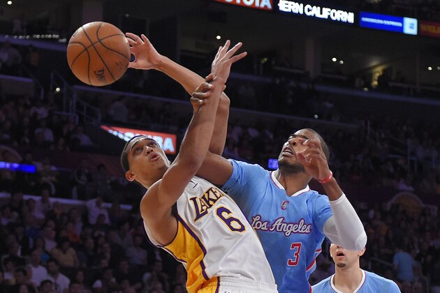 Los Angeles Clippers guard Chris Paul, right, fouls Los Angeles Lakers guard Jordan Clarkson during the first half of an NBA basketball game, Sunday, April 5, 2015, in Los Angeles. (AP Photo/Mark J. Terrill)