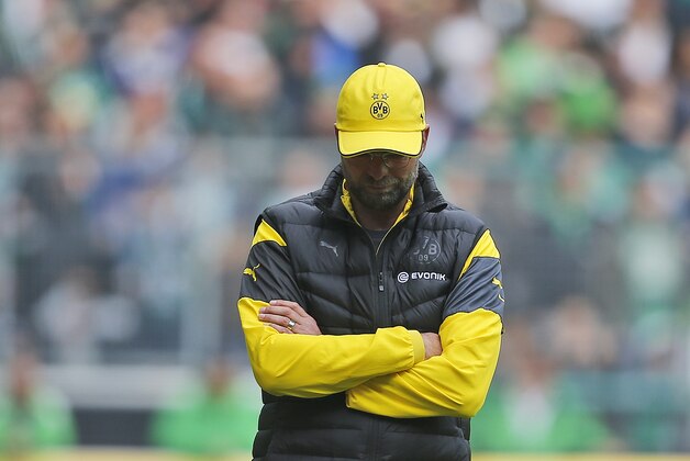Dortmund's head coach Juergen Klopp looks down  during the German first division Bundesliga soccer match between Borussia Moenchengladbach and Borussia Dortmund in Moenchengladbach, Germany, Saturday, April 11, 2015. (AP Photo/Frank Augstein)