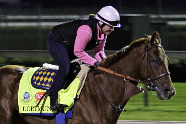 Exercise rider Dana Barnes gallops Kentucky Derby entrant Dortmund at Churchill Downs in Louisville, Ky., Friday, May 1, 2015.  (AP Photo/Garry Jones)