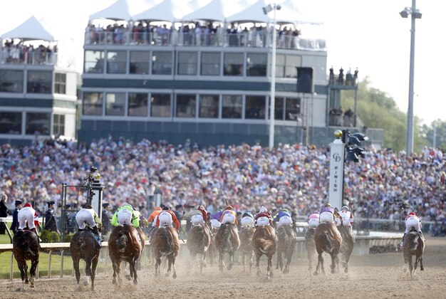 May 3, 2014; Louisville, KY, USA; The field heads towards the finish line during the 2014 Kentucky Derby at Churchill Downs. Mandatory Credit: Brian Spurlock-USA TODAY Sports