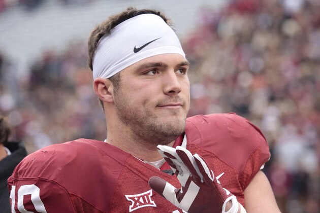 NORMAN, OK - DECEMBER 6:  Tight end Blake Bell #10 of the Oklahoma Sooners claps during a ceremony for graduating seniors before the game against the Oklahoma State Cowboys December 6, 2014 at Gaylord Family-Oklahoma Memorial Stadium in Norman, Oklahoma. The Cowboys defeated the Sooners 38-35 in overtime.  (Photo by Brett Deering/Getty Images)