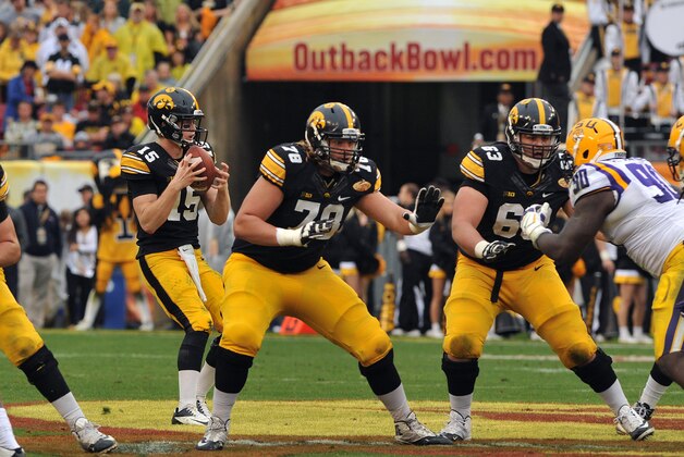 TAMPA, FL -  JANUARY 1:  Offensive lineman Andrew Donnal #78 and Austin Blythe #63 of the Iowa Hawkeyes block as quarterback Steve Manders #15 drops back to pass against the LSU Tigers January 1, 2014  in the Outback Bowl at Raymond James Stadium in Tampa, Florida.  (Photo by Al Messerschmidt/Getty Images)