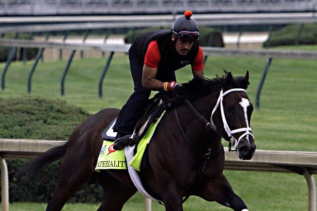 Kentucky Derby entrant Materiality, ridden by exercise rider Carlos Cano, gallops at Churchill Downs in Louisville, Ky., Thursday, April 30, 2015.  (AP Photo/Garry Jones)