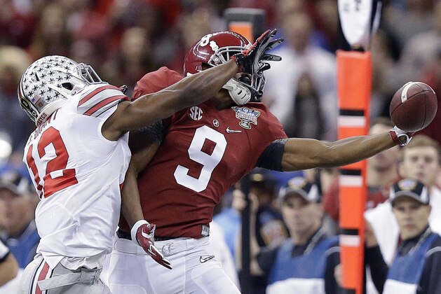 Alabama wide receiver Amari Cooper (9) tries to catch the ball as Ohio State cornerback Doran Grant (12) defends during the Sugar Bowl NCAA college football playoff semifinal game, Thursday, Jan. 1, 2015, in New Orleans. (AP Photo/Brynn Anderson)