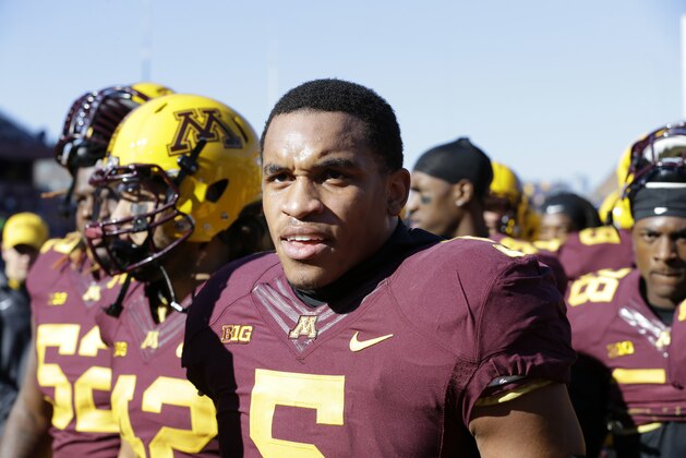 Minnesota linebacker Damien Wilson walks off the field with teammates after warmups before an NCAA college football game against Northwestern in Minneapolis Saturday, Oct. 11, 2014. (AP Photo/Ann Heisenfelt)