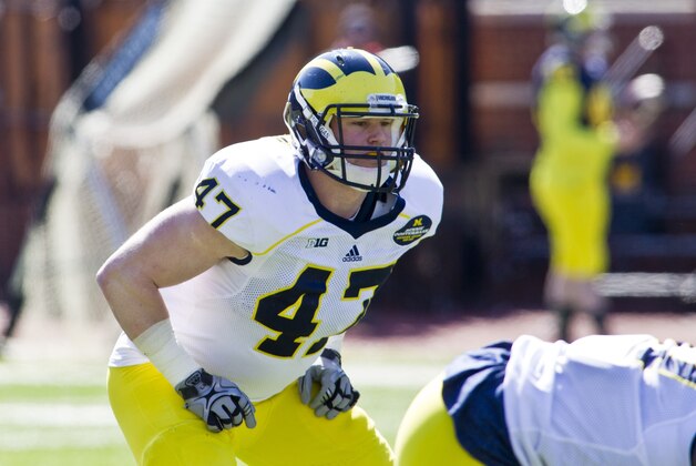 Michigan linebacker Jake Ryan (47) gets into his stance behind his defensive line, during the football team's annual spring game, Saturday, April 5, 2014, in Ann Arbor, Mich. (AP Photo/Tony Ding)