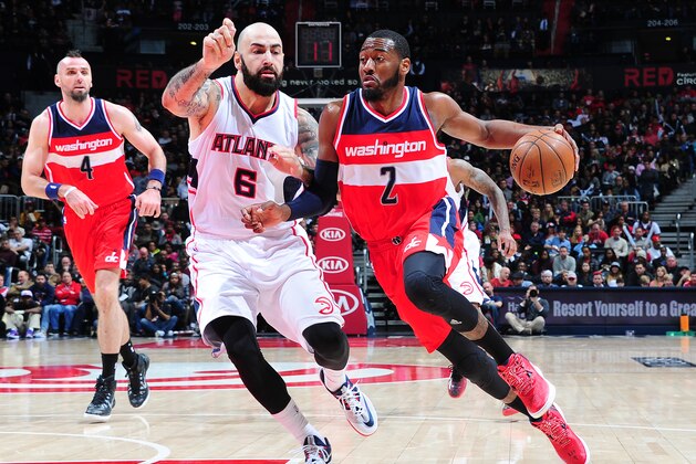 ATLANTA, GA - JANUARY 11: John Wall #2 of the Washington Wizards drives against Pero Antic #6 of the Atlanta Hawks on January 11, 2015 at Philips Arena in Atlanta, Georgia.  NOTE TO USER: User expressly acknowledges and agrees that, by downloading and/or using this Photograph, user is consenting to the terms and conditions of the Getty Images License Agreement. Mandatory Copyright Notice: Copyright 2015 NBAE (Photo by Scott Cunningham/NBAE via Getty Images)