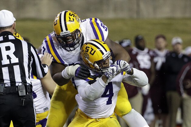 LSU linebacker Kwon Alexander (4) and defensive tackle Davon Godchaux (57) celebrate after sacking Texas A&M quarterback Kyle Allen during the third quarter of an NCAA college football game Thursday, Nov. 27, 2014, in College Station, Texas. LSU won 23-17. (AP Photo/David J. Phillip)
