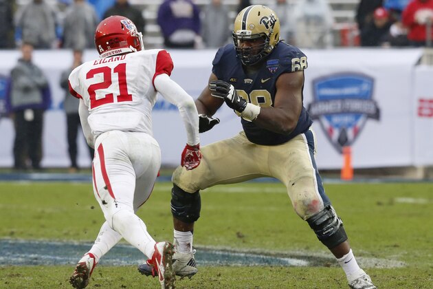 Houston defensive end Eric Eiland (21) and Pittsburgh offensive lineman T.J. Clemmings (68) during the second half of the Armed Forces Bowl NCAA college football game, Friday, Jan. 2, 2015, in Fort Worth. Texas. Houston won 35-34. (AP Photo/Sharon Ellman)