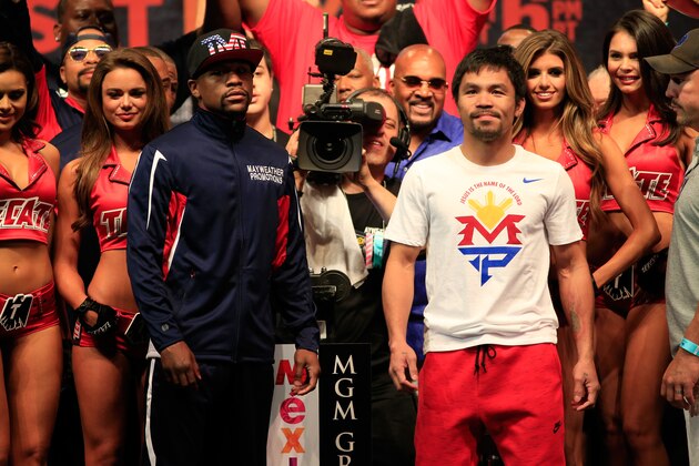 LAS VEGAS, NV - MAY 01:  Floyd Mayweather Jr. (L) and Manny Pacquiao pose during their official weigh-in on May 1, 2015 at MGM Grand Garden Arena in Las Vegas, Nevada. The two will face each other in a welterweight unification bout on May 2, 2015 in Las Vegas.  (Photo by Jamie Squire/Getty Images)