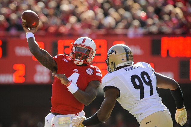 LINCOLN, NE - NOVEMBER 1: Quarterback Tommy Armstrong Jr. #4 of the Nebraska Cornhuskers throws over defensive end Ryan Russell #99 of the Purdue Boilermakers during their game at Memorial Stadium on November 1, 2014 in Lincoln, Nebraska.  (Photo by Eric Francis/Getty Images)