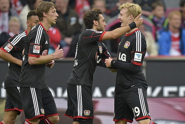 Leverkusen's scorer Julian Brandt, right, is celebrated by Hakan Calhanoglu from Turkey during the German first division Bundesliga soccer match between 1. FC Cologne and Bayer Leverkusen in Cologne, Germany, Saturday, April 25, 2015. (AP Photo/Martin Meissner)