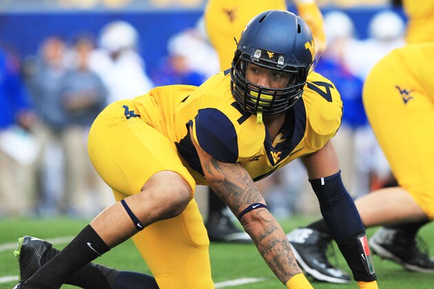 West Virginia's Shaquille Riddick (4) prepares for a play during their NCAA college football game against Kansas  in Morgantown, W.Va., Saturday, Oct. 4, 2014. West Virginia won 33-14. (AP Photo/ Chris Jackson)
