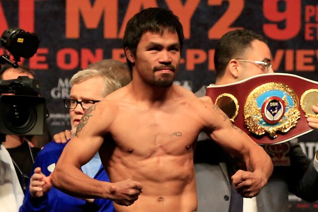 LAS VEGAS, NV - MAY 01:  Manny Pacquiao poses on the scale during his official weigh-in on May 1, 2015 at MGM Grand Garden Arena in Las Vegas, Nevada. Pacquiao will face Floyd Mayweather Jr. in a welterweight unification bout on May 2, 2015 in Las Vegas.  (Photo by Jamie Squire/Getty Images)