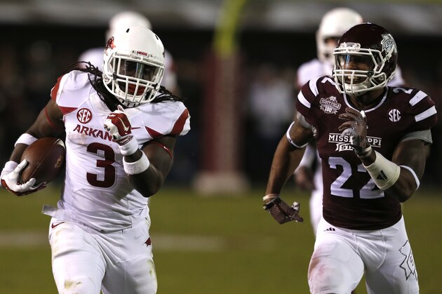 STARKVILLE, MS-NOVEMBER 1:  Alex Collins #3 of the Arkansas Razorbacks breaks free for a long first down run as Matthew Wells #22 of the Mississippi State Bulldogs chases him down in the second half at Davis Wade Stadium on November 1, 2014, in Starkville, Mississippi. (Photo by Butch Dill/Getty Images)