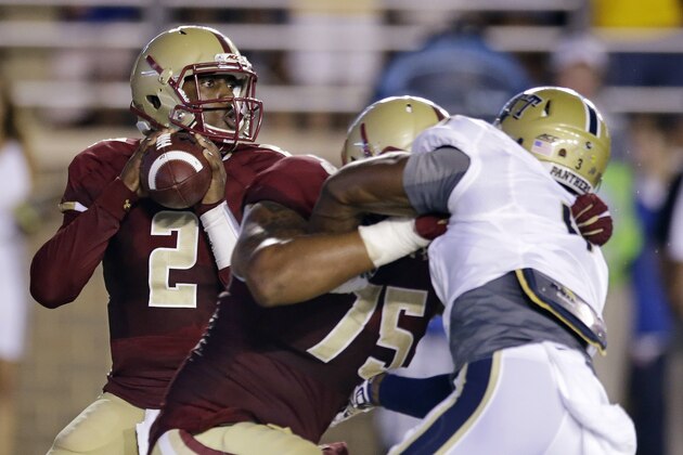 Boston College quarterback Tyler Murphy (2) drops back while looking for a receiver as offensive linesman Ian Silberman (75) holds off Pittsburgh linebacker Nicholas Grigsby (3) during the first quarter of an NCAA college football game on Friday, Sept. 5, 2014, in Boston. (AP Photo/Stephan Savoia)