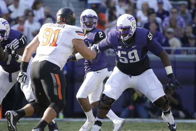 TCU offensive tackle Tayo Fabuluje (59) defends against a rush by Oklahoma State defensive tackle James Castleman (91) during an NCAA college football game, Saturday, Oct. 18, 2014, in Fort Worth, Texas. (AP Photo/Tony Gutierrez)