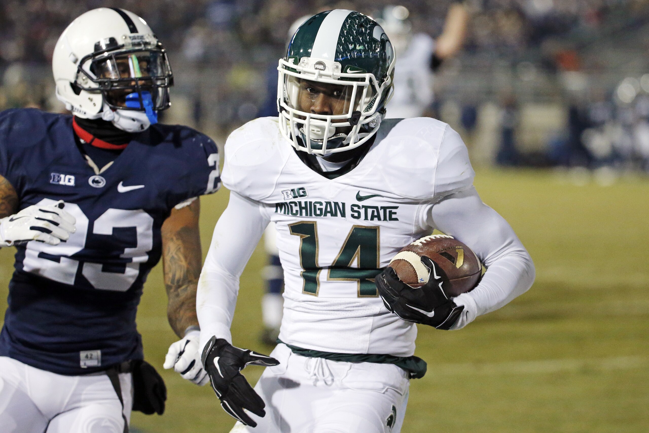 Michigan State wide receiver Tony Lippett (14) scores past Penn State cornerback Jordan Lucas (23) on a pass from quarterback Connor Cook during the second half of an NCAA college football game in State College, Pa., Saturday, Nov. 29, 2014. (AP Photo/Gene J. Puskar)