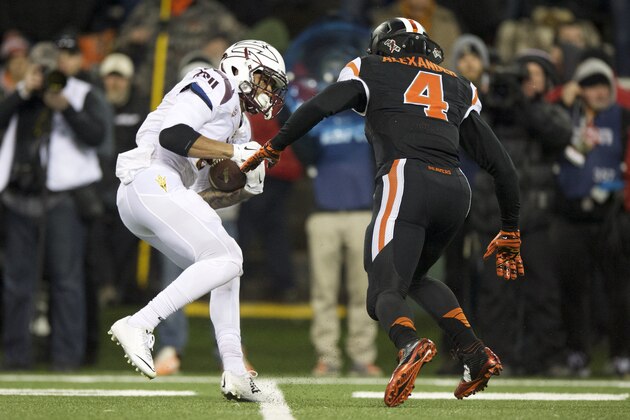 Arizona State tailback D.J. Foster (8) has no room to run as he pursued by Oregon State defender D.J. Alexander (4) during the first quarter of an NCAA college football game in Corvallis, Ore., Saturday, Nov. 15, 2014. (AP Photo/Troy Wayrynen)