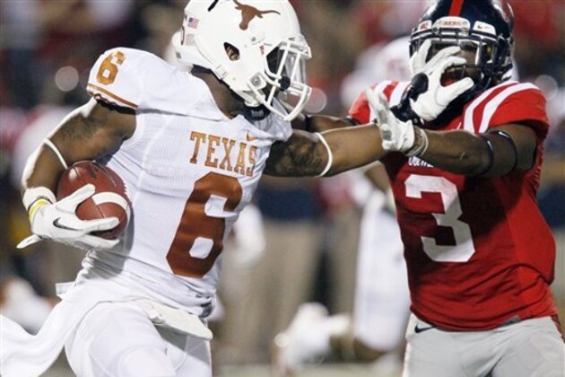 Texas cornerback Quandre Diggs (6) fights off Mississippi running back Jeff Scott (3) as he runs upfield with a 11-yard interception during the second quarter of an NCAA college football game in Oxford, Miss., Saturday, Sept. 15, 2012. (AP Photo/Rogelio V. Solis)