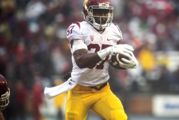 Southern California tailback Javorius Allen (37) gets around Washington State linebacker Darryl Monroe (13) during the first quarter of an NCAA college football game, Saturday, Nov. 1, 2014, at Martin Stadium in Pullman, Wash. Allen gained 114 yards on 19 carries as Southern California won 44-17. (AP Photo/Dean Hare)