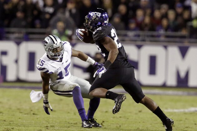 TCU running back Aaron Green (22) cuts against Kansas State defensive back Randall Evans (15) on his way to scoring a touchdown during the second half of an NCAA college football game Saturday, Nov. 8, 2014, in Fort Worth, Texas. TCU won 41-20. (AP Photo/LM Otero)