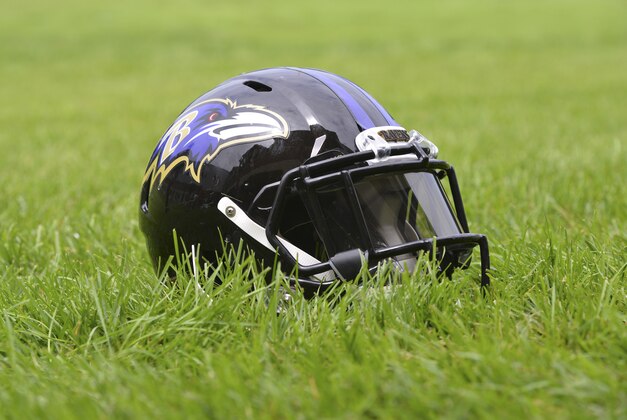 Jul 24, 2014; Owings Mills, MD, USA;  A detailed view of an Baltimore Ravens helmet  in the grass after practice at Under Armour Performance Center. Mandatory Credit: Tommy Gilligan-USA TODAY Sports