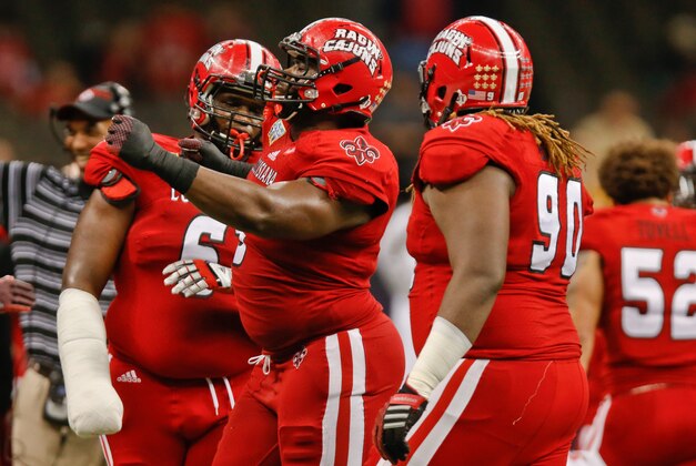 Dec 20, 2014; New Orleans, LA, USA; Louisiana-Lafayette Ragin Cajuns defensive lineman Christian Ringo (9) celebrates after a sack with teammates defensive lineman Justin Hamilton (6) and defensive tackle Jacoby Briscoe (90) during the second half of the New Orleans Bowl against the Nevada Wolf Pack at the Mercedes-Benz Superdome. Louisiana-Lafayette defeated Neveda 16-3.  Mandatory Credit: Derick E. Hingle-USA TODAY Sports