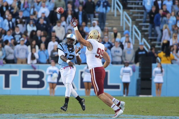 North Carolina quarterback Marquise Williams passes over Boston College defensive lineman Brian Mihalik in an NCAA college football game in Chapel Hill, N.C., Saturday, Oct. 26, 2013. North Carolina won 34-10. (AP Photo/Nell Redmond)